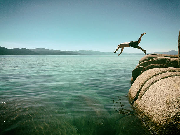 man jumping into lake tahoe, california - water weed imagens e fotografias de stock