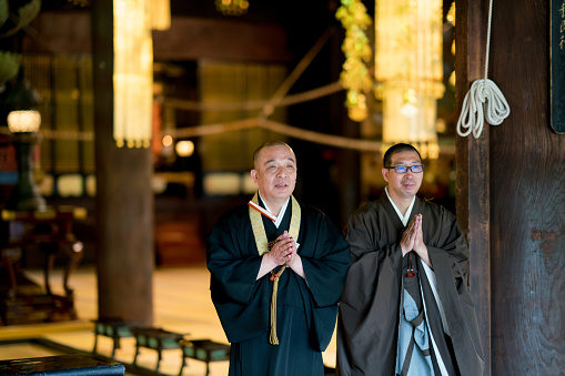 Japanese monks praying at a sacred temple