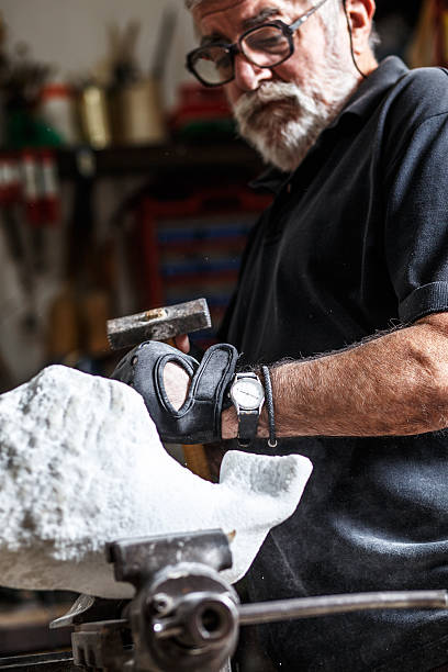 istock Senior sculptor working on his sculpture 541995706