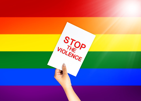Stop the violence on card with LBGT flag background