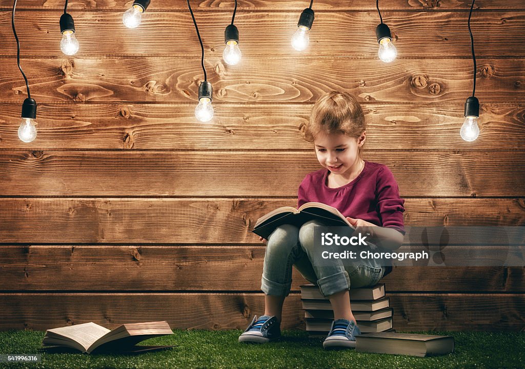girl reading a book Cute little child girl reading a book. Book Stock Photo