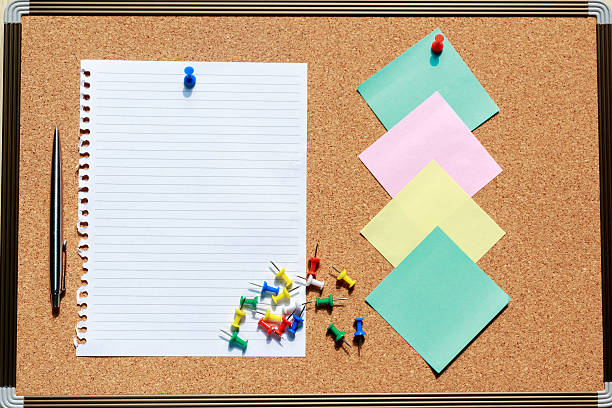 istock Top view of blank notebook on cork board stationery 541997588