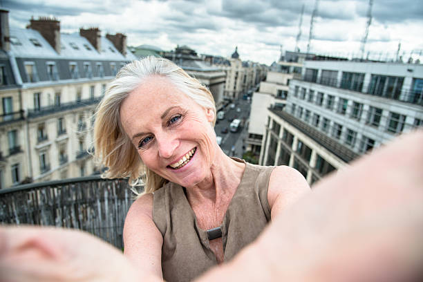 french woman take a selfie on the rooftop in paris