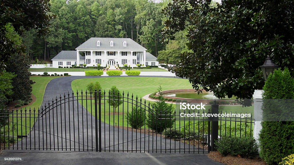 Whit House Large mansion with water fountain and iron gate at the entrance. Gate Stock Photo