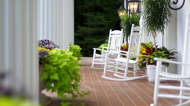 Rocking Chairs Rocking chairs sitting outside on the front porch of a home with white columns. porch stock pictures, royalty-free photos & images