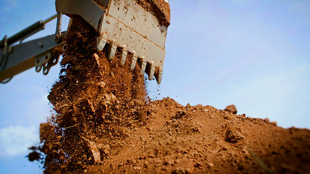 istock Backhoe emptying bucket full of dirt. 542002430