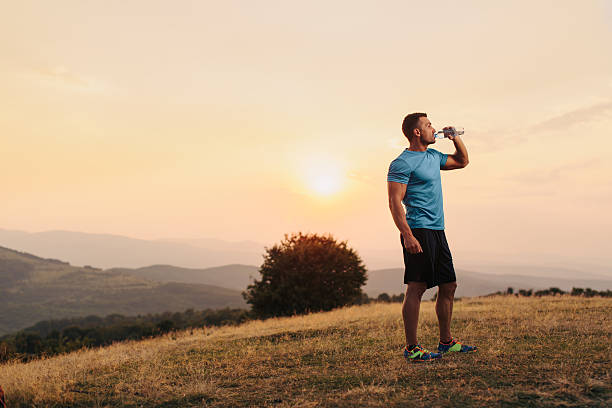istock Athletic man drinking water outdoor 542002784