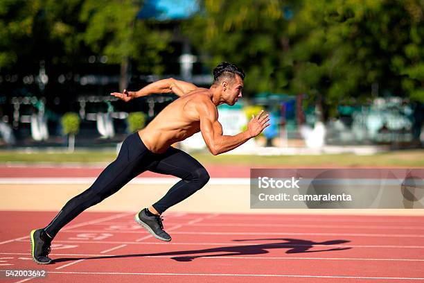 Young Muscular Man Ready To Start A Track Meet Stock Photo - Download Image Now - Active Lifestyle, Activity, Adult