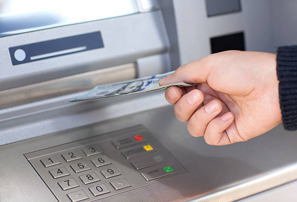 istock man receives money from ATM 542005172
