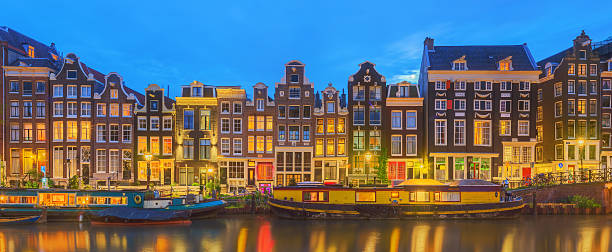 istock Amstel river, canals and night view of Amsterdam, Netherlands. 542005292