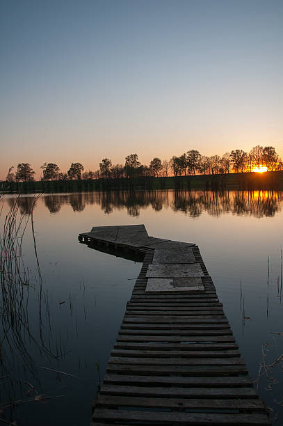 istock Wooden jetty on lake under the sunset 542006916