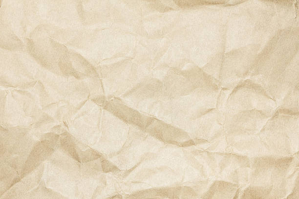 istock Brown paper sheet. Closeup recycled crumpled brown paper texture 542010772