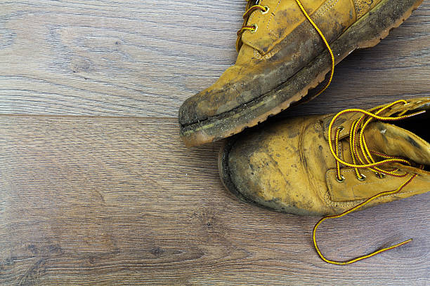 istock Muddy work boots on a wooden floor 542011112