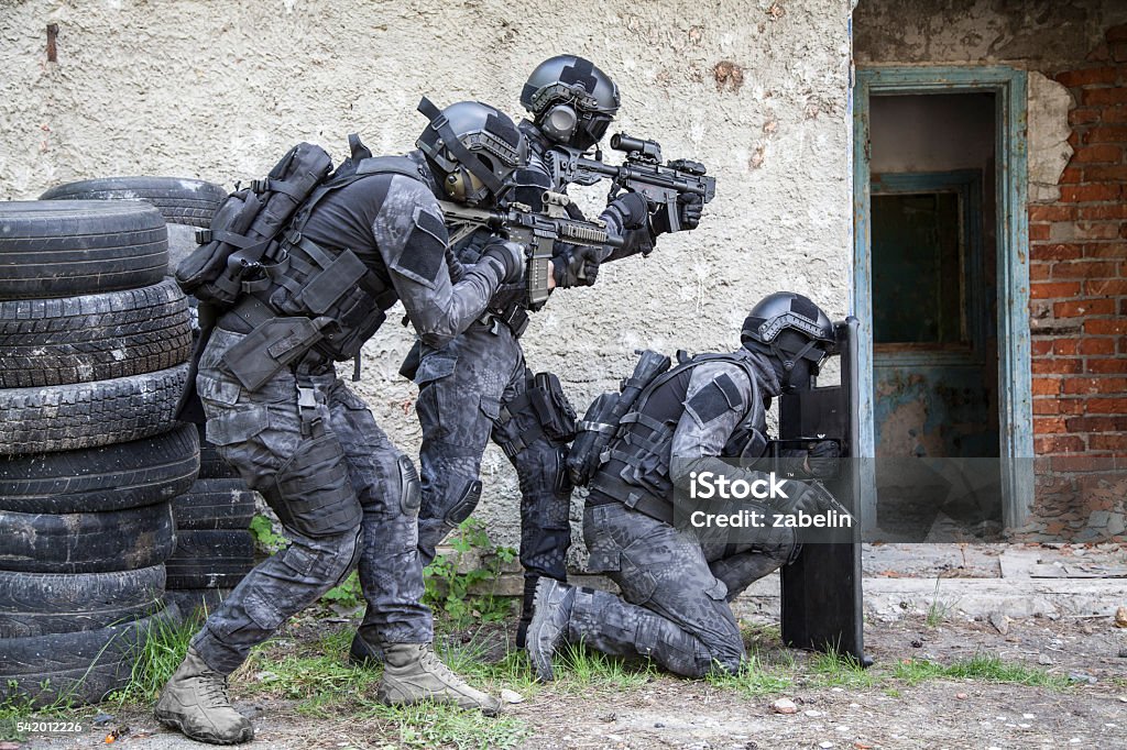 Spec ops police officer SWAT Spec ops police officers SWAT in black uniform in action Special Forces Stock Photo