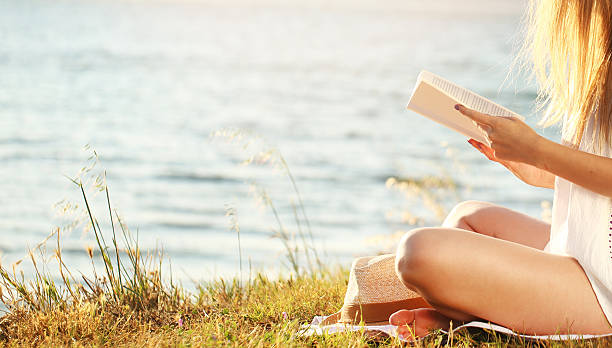 Girl in dress reading book. Sunny morning.