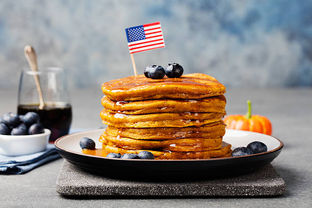 istock Pumpkin pancakes with maple syrup, blueberries American flag on top 542013122