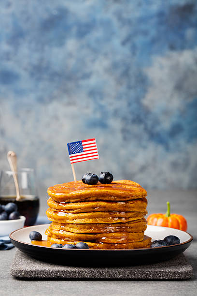 istock Pumpkin pancakes with maple syrup, blueberries American flag on top 542013306