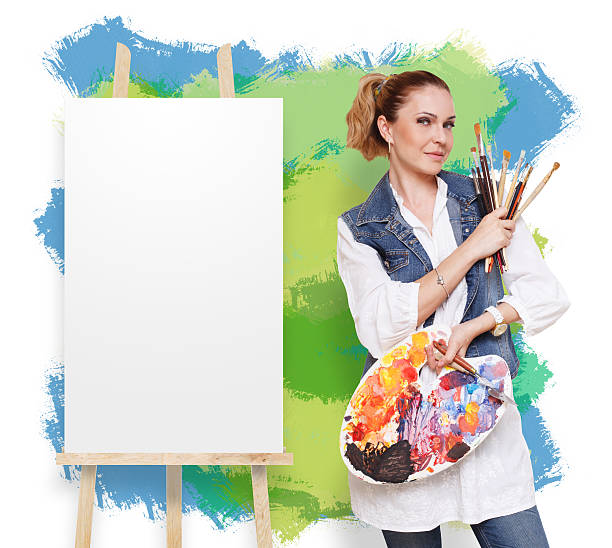 Happy artist. Woman with art tools. Female painter with brushes and palette. Empty easel with canvas at colorful background with copy space. Art classes for adults, education concept.