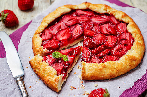 Strawberry Strawberry galette on a white wood background. toning. selective focus crostata stock pictures, royalty-free photos & images