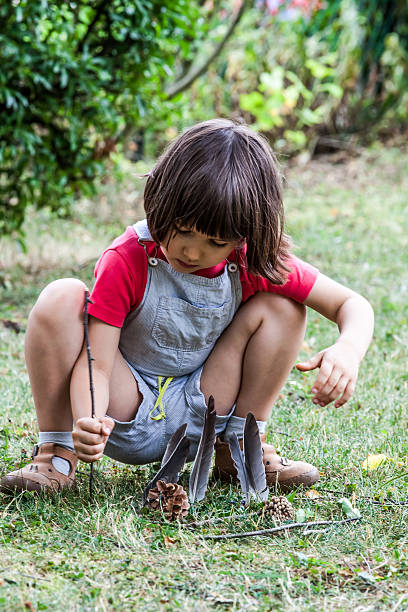 istock playful young preschool kid experimenting with wood sticks and feathers 542015226