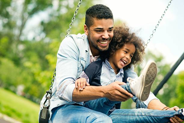 Having fun with daughter. Father having fun with his daughter in the park swinging stock pictures, royalty-free photos & images