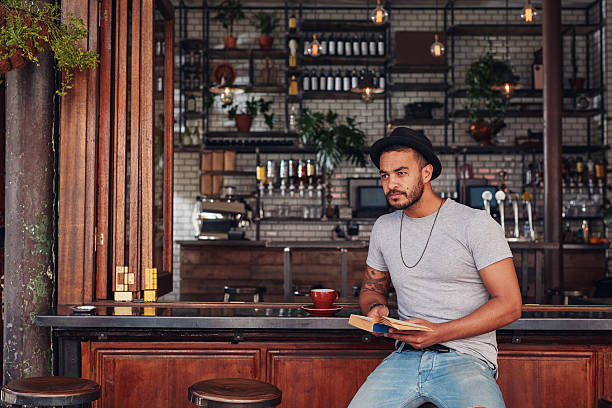 istock Trendy young male sitting at a cafe counter 542065304