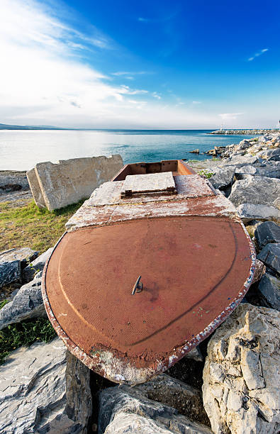 Dilapidated boat by the seaside at Greece stock photo