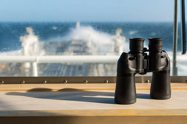 istock Binocular on the windowsill of navigation bridge. 542065884