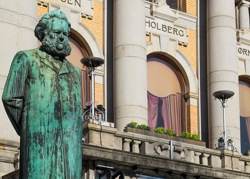Statue of Henrik Ibsen, one of the greatest playwrights ever, in front of the National Theatre in Oslo, Norway. The statue was made by Stephan Sinding and erected in 1899. Ibsen died in 1906.