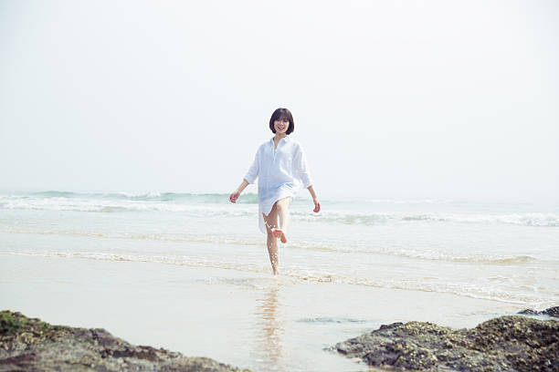 istock girl stand beside the ocean 542071560