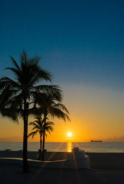 Corduroy Waves with sea oats and fishing boat in sunrise.