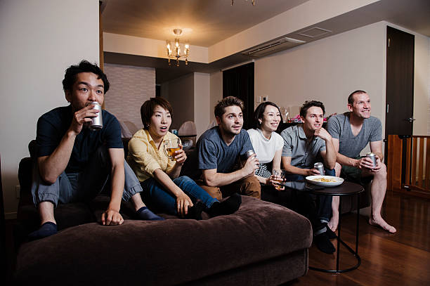 istock Group of friends watching TV match and cheering 542075018