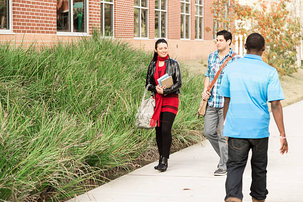 istock Education: Diverse group of college students walk to class.  Campus. 542079260