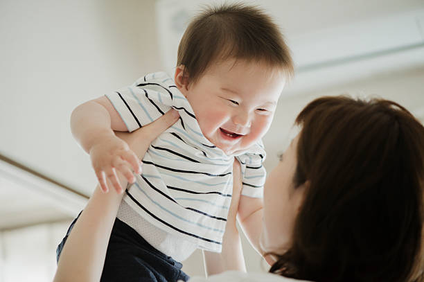 istock Mother lifting a smiling baby. 542081298