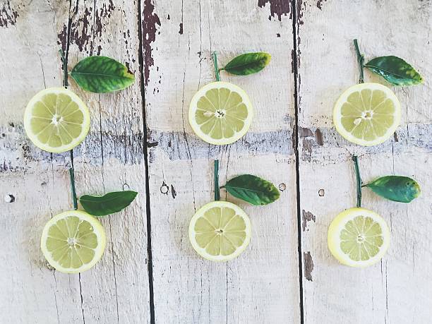 fresh lemons with green leaves on the wood