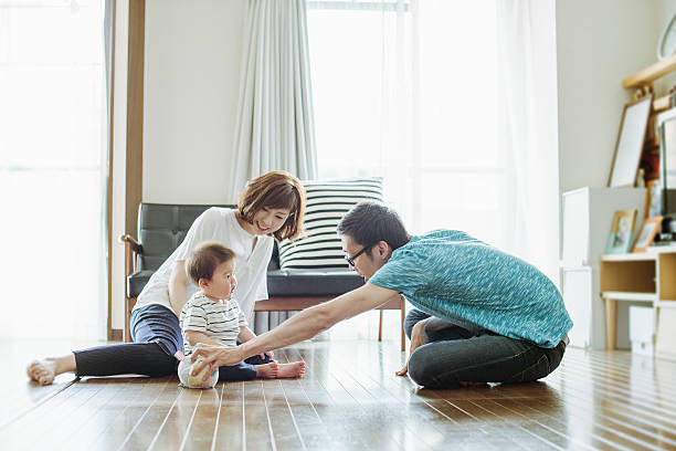 Happy family with newborn baby. Asian parents having a good time with cute baby boy on holiday at home. 3 6 months stock pictures, royalty-free photos & images