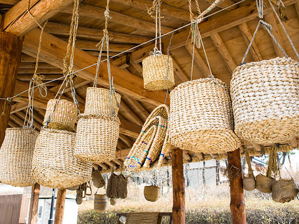 Colorful woven straw baskets with leather handles at a St. Augustine farmers' market.