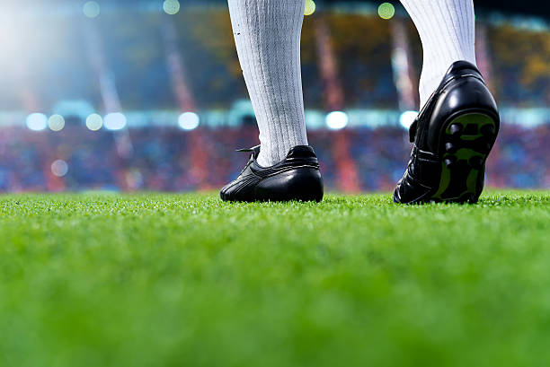 ready to play soccer match Foot of soccer player or football player walk on green grass ready to play soccer match for the winner with soccer stadium backgrounds. football boot stock pictures, royalty-free photos & images