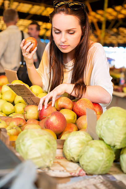 istock Young woman choosing red apples 542085132