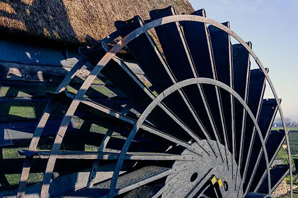 Close-up of the paddlewheel of a historic Dutch polder windmill built in 1699. It is a sunny day in the winter season.