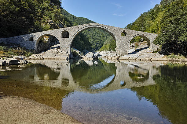 istock Reflection of Devil's Bridge in Arda river and Rhodopes mountain 542089946