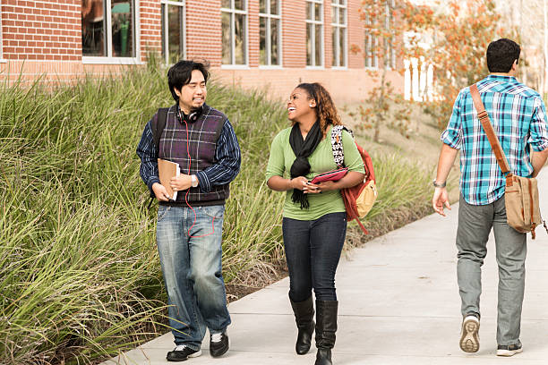 istock Education: Diverse group of college students walk to class.  Campus. 542091170