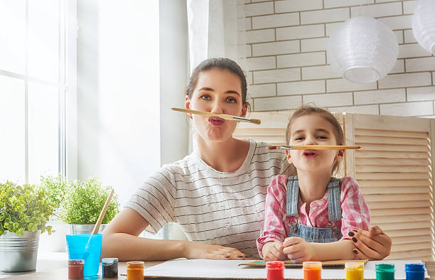 istock Mother and daughter paint 542092344