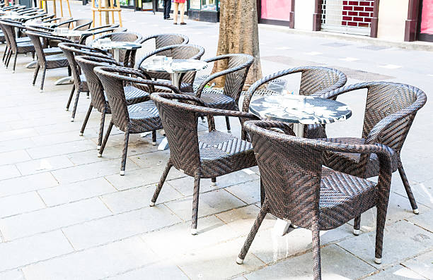 istock Row of little tables with chairs  in open cafe 542092624