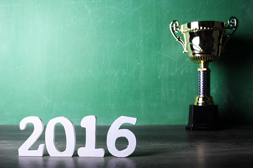 winning trophy with green calkboard background and 2016 text
