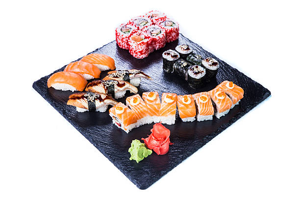 istock Sushi Set  and sushi rolls on black stone slate. 542094668