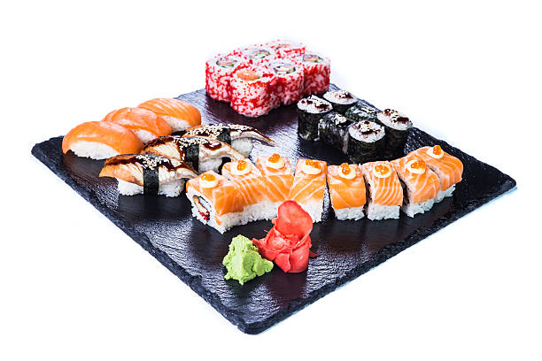 istock Sushi Set  and sushi rolls on black stone slate. 542094760