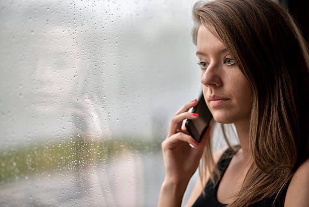 istock Sad woman using smartphone at home 542098610