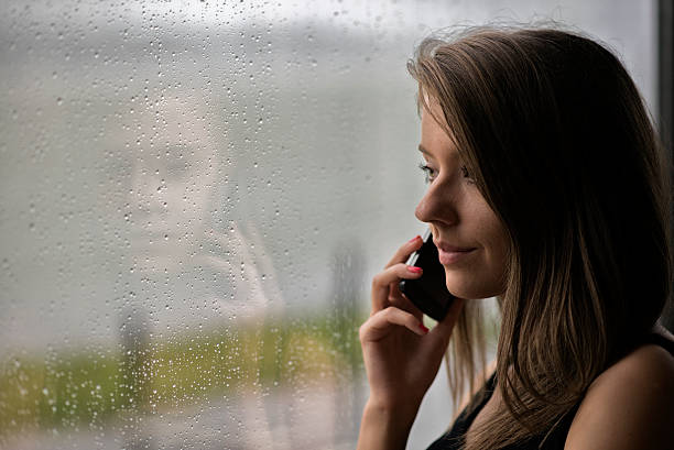 istock Woman looking through a window getting bad news 542098722