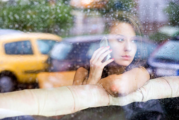 istock Woman looking through a window getting bad news 542099638